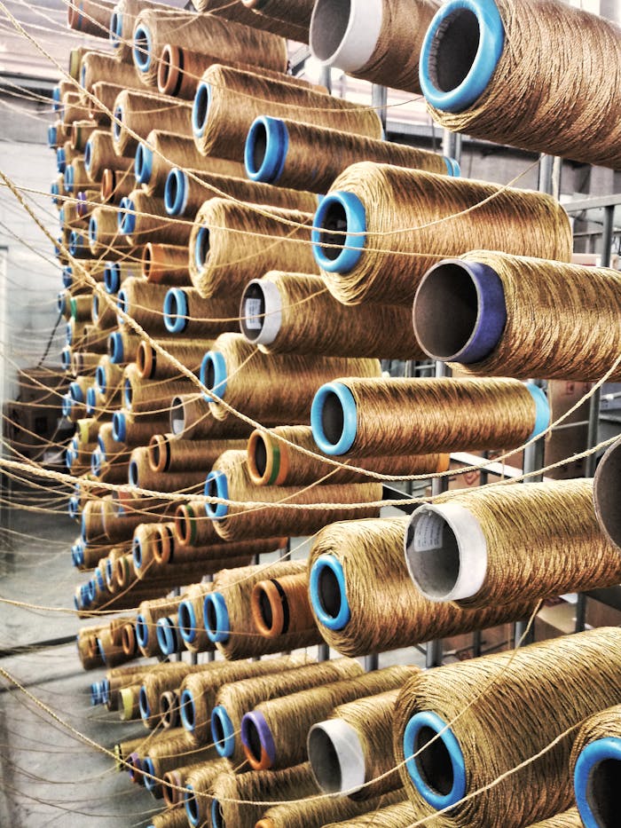 who-we-are Rows of sewing thread spools in a São Paulo factory assembly line.